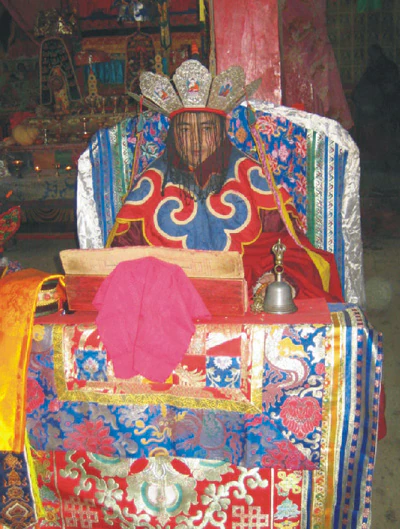 An ornate ceremonial seat and ritual implements arranged for an empowerment in Qinghai.