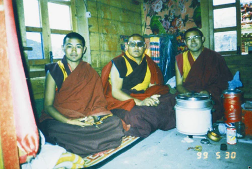 Hor shul Khenpo Gelek Palsang Rinpoche, Tulku Duodun, and Khenpo Tsultrim Lodrö sit together in monastic robes inside a wooden room.
