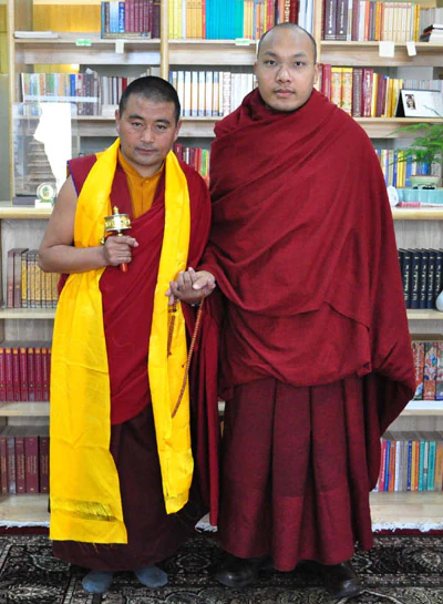 The Seventeenth DB Dharma King and Hor shul Khenpo Gelek Palsang Rinpoche stand side by side in monastic robes before bookshelves.