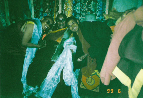 Hor shul Khenpo Gelek Palsang Rinpoche, his teacher, Tulku Dongga, and others sit together indoors.